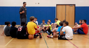 Coach Armando addressing boys at a Centennials basketball clinic in South Denver, Colorado